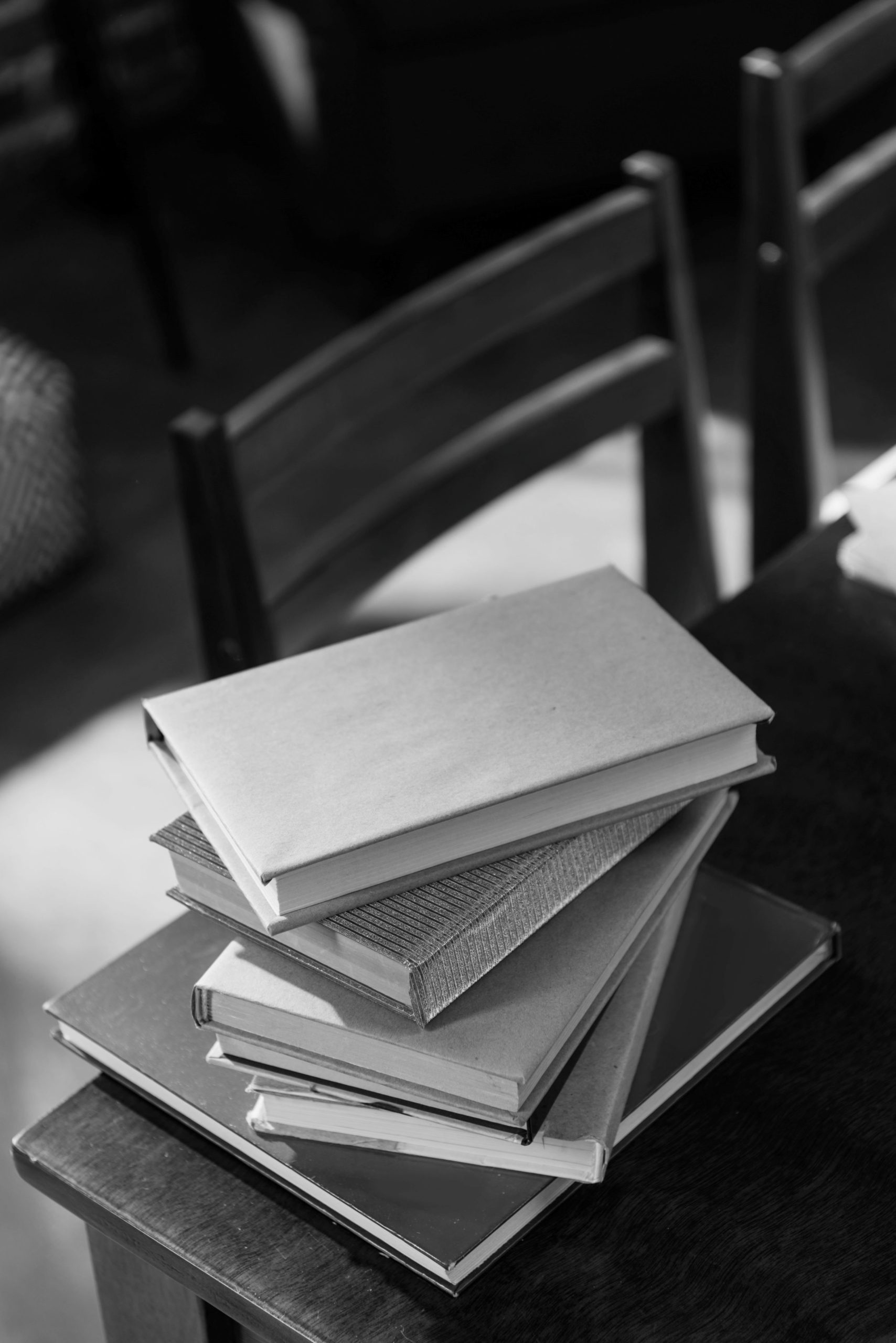 close-up-of-heap-of-books-on-wooden-tabletop-with-2023-11-27-05-11-16-utc books on table for services page